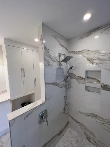 Marble shower remodel with glass enclosure